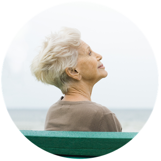 old woman sitting by the sea