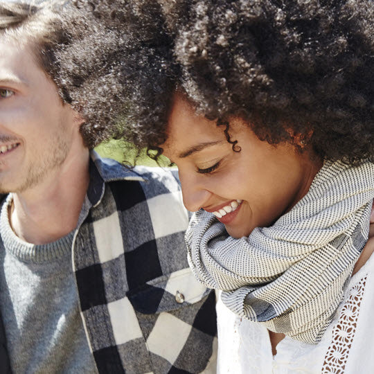 A joyful moment captured with a man and woman smiling together, reflecting happiness and connection.