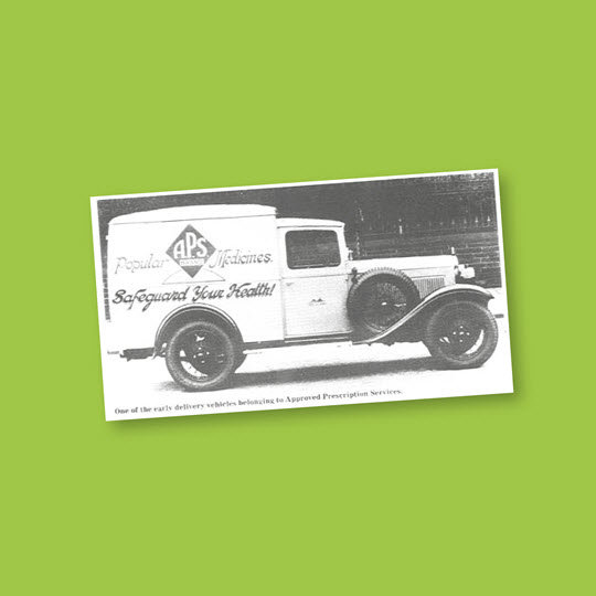 An old photo of a truck displaying the letters "pbs" prominently on its side.