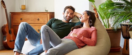 Woman and her partner on a beanbag having a conversation