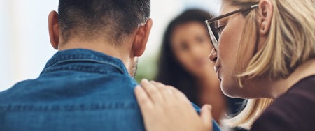 Woman comforting her husband during a therapy session